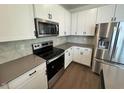 Modern kitchen featuring stainless steel appliances, a microwave and beautiful countertops at 10548 Brookside Reserve Rd, Raleigh, NC 27614