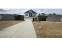 Traditional style home showcasing blue and grey siding and a two-car garage on a sprawling lot at 165 Knoll Way, Sanford, NC 27332