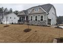 Charming home featuring stone accents, a covered porch, and a freshly installed lawn at 200 Ironwood Lot 39 Blvd, Youngsville, NC 27596
