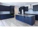Modern kitchen with sleek blue cabinets, granite countertops, and a stylish island at 200 Ironwood Lot 39 Blvd, Youngsville, NC 27596