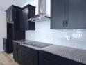 Close-up of the gourmet kitchen with stainless steel hood and dark cabinetry at 200 Ironwood Lot 39 Blvd, Youngsville, NC 27596