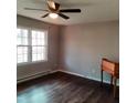 Living room with dark laminate wood flooring and a ceiling fan at 2800 Coleman Loop Rd, Hillsborough, NC 27278