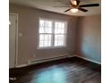 Living room with dark laminate wood flooring and a ceiling fan at 2800 Coleman Loop Rd, Hillsborough, NC 27278