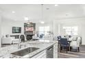 Spacious kitchen island with granite countertop, sink, and dishwasher; open to living area at 418 Providence Springs Ln, Fuquay Varina, NC 27526