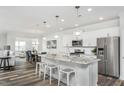 Modern kitchen with white cabinets, granite countertops, and stainless steel appliances at 418 Providence Springs Ln, Fuquay Varina, NC 27526