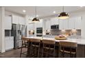 Spacious kitchen with white cabinets, quartz countertops, and stainless steel appliances at 902 Brookfield Dr, Gibsonville, NC 27249