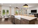 Modern kitchen with a farmhouse sink, stainless steel appliances, and an island at 902 Brookfield Dr, Gibsonville, NC 27249