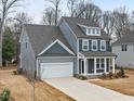 A view of a two-story house from above the house highlighting the driveway, covered porch, and garage at 906 Brookfield Dr, Gibsonville, NC 27249