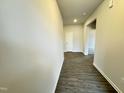 Inviting hallway showcasing modern wood-look flooring leading to other rooms at 166 Vega Loop, Sanford, NC 27330