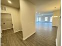 Open-concept living space with wood-look floors and ample natural light from numerous windows at 166 Vega Loop, Sanford, NC 27330