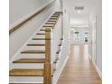 Elegant staircase with wood treads and white risers leads to the upper level at 538 Eversden Dr, Zebulon, NC 27597