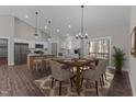 Bright dining area featuring a wooden table, stylish chairs, and a modern chandelier, adjacent to the kitchen at 125 Leisure Ln, Louisburg, NC 27549