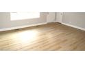 Spacious bedroom featuring hardwood floors and a large window for plenty of natural light at 2253 Nc Highway 96 S, Franklinton, NC 27525