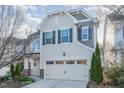 Beautiful home with a two-car garage, complemented by stone details and gray shutters, nestled in a serene neighborhood at 226 Begen St, Morrisville, NC 27560