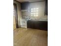 Functional kitchen with a white range, double basin sink, and vintage-style flooring at 420 E Hinton St, Clayton, NC 27520