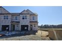 A newly constructed townhome featuring a covered exterior awaiting final finishing at 3852 Well Fleet Drive, Willow Springs, NC 27592