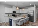 Modern kitchen with stainless steel appliances and island at 3928 Well Fleet Drive, Fuquay Varina, NC 27526