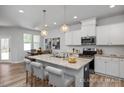 Modern kitchen with island and stainless steel appliances at 3930 Well Fleet Drive, Willow Springs, NC 27592