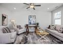 Cozy living room boasts neutral paint, eclectic area rug, and comfortable furniture at 3930 Well Fleet Drive, Fuquay Varina, NC 27526