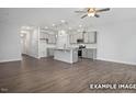 Open-concept living space with hardwood floors, neutral colors, and modern kitchen with island at 3932 Well Fleet Drive, Fuquay Varina, NC 27526