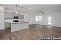 Spacious open-concept living area featuring hardwood floors and bright kitchen at 3932 Well Fleet Drive, Fuquay Varina, NC 27526