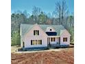 The new construction boasts white siding and elegant black-framed windows at 40 Moonraker Dr, Spring Hope, NC 27882