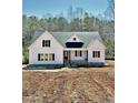 A well-built new home features white siding and a welcoming front entrance at 40 Moonraker Dr, Spring Hope, NC 27882