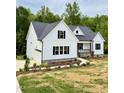 New construction home with a two car garage, white siding, black shutters and landscaped flower beds at 40 Moonraker Dr, Spring Hope, NC 27882