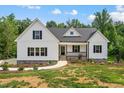 Charming two-story home with stone accents, black shutters, and well-manicured lawn at 40 Moonraker Dr, Spring Hope, NC 27882