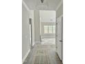 The light gray hallway leads to a living space with large windows for natural light at 40 Moonraker Dr, Spring Hope, NC 27882