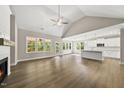 Spacious living room featuring a vaulted ceiling, fireplace, hardwood floors, and lots of natural light at 40 Moonraker Dr, Spring Hope, NC 27882