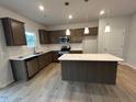 A kitchen featuring wood-grain cabinets, stainless appliances, an island, and white subway tile at 60 Calabria Ct, Franklinton, NC 27525