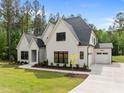 A spacious, white brick home with an attached two-car garage, complemented by a well-manicured lawn at 7813 Ailesbury Rd, Wake Forest, NC 27587
