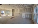 Spacious living room featuring large windows offering ample natural light at 85 Windchime Ct, Fuquay Varina, NC 27526