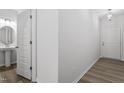 Modern bathroom with pedestal sink, and wood-look flooring at 1040 Westerland Way # 212, Durham, NC 27703