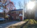 Brick duplex with red front door, driveway, and landscaping at 1714 Fox Hollow Dr, Raleigh, NC 27610