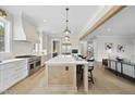 Spacious kitchen features a large island with seating, stainless appliances, and flows into an open-concept living area at 2908 Frances Marie Ln, Raleigh, NC 27603