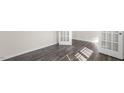 Well-lit room featuring two doors, neutral walls, and wood-look flooring at 420 Blue Aspen Dr, Fuquay Varina, NC 27526