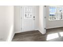 Bright entryway with decorative glass front door and wood-look flooring at 420 Blue Aspen Dr, Fuquay Varina, NC 27526