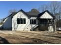 Rear view of new construction home with a covered porch and dark trim at 4804 Jefferson Ln, Raleigh, NC 27616