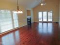 Spacious living room featuring hardwood floors, fireplace, and access to backyard at 513 Port Dr, Henderson, NC 27537