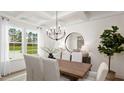 Bright dining room featuring a large table, chandelier, and view of backyard at 814 Brookfield Dr, Gibsonville, NC 27249