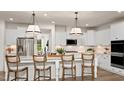 Modern white kitchen with stainless steel appliances and large island at 814 Brookfield Dr, Gibsonville, NC 27249