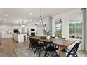 Open concept kitchen and dining area with large island and hardwood floors at 814 Brookfield Dr, Gibsonville, NC 27249