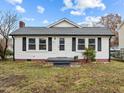 White house with gray roof, small front yard, and steps leading to the front door at 826 Carter Ave, Durham, NC 27703