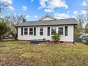 White house with gray roof, small front yard, and steps leading to the front door at 826 Carter Ave, Durham, NC 27703