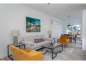 Bright living room featuring modern furniture, an area rug, and an artistic painting at 110-A S Hyde Park Ave, Durham, NC 27703