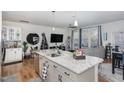 Modern kitchen island with granite countertops and stainless steel sink in an open concept living space at 236 George Pine Way, Knightdale, NC 27545
