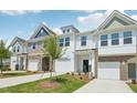 Attractive townhouse exteriors with diverse siding, lawns, driveways, and blue sky background at 43 Honeydew Way, Clayton, NC 27520