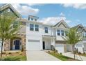 Attractive townhouse exteriors with diverse siding, lawns, and blue sky background at 43 Honeydew Way, Clayton, NC 27520